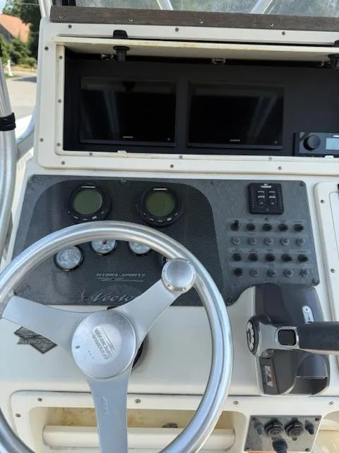 Slide: The Image of Console of 2003 Hydra-Sports Vector 2400 CC boat with steering wheel and controls. - 12