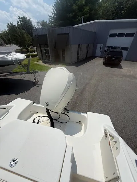 Slide: The Image of 2003 Hydra-Sports Vector 2400 CC boat with outboard motor, parked near a building. - 3