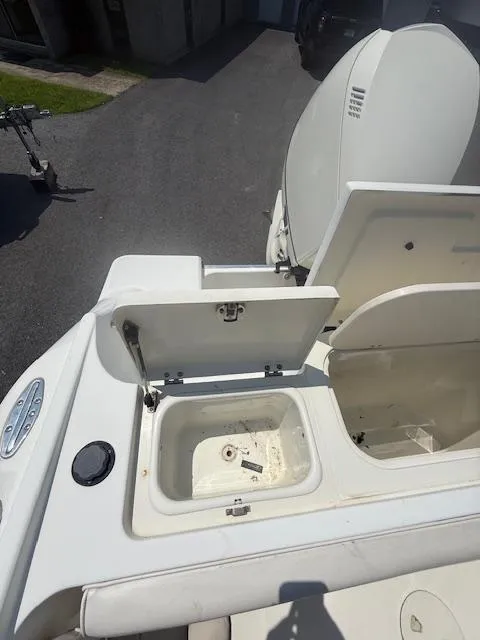Slide: The Image of 2003 Hydra-Sports Vector 2400 CC boat with open storage compartments. - 6