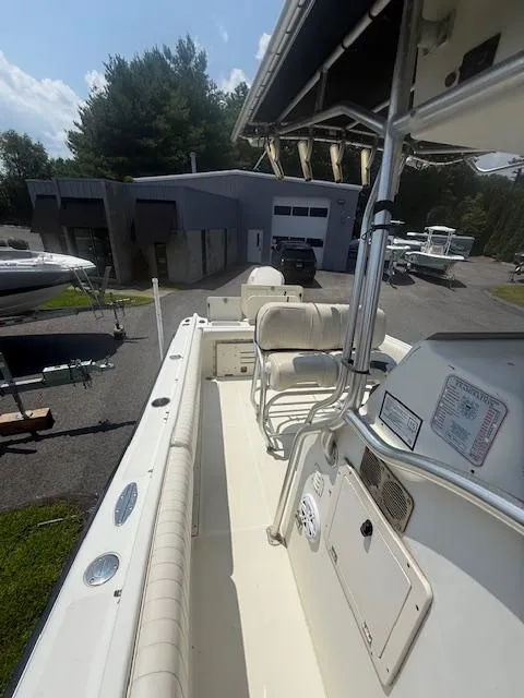 Slide: The Image of 2003 Hydra-Sports Vector 2400 CC boat interior with seating and control panel, parked outdoors. - 8