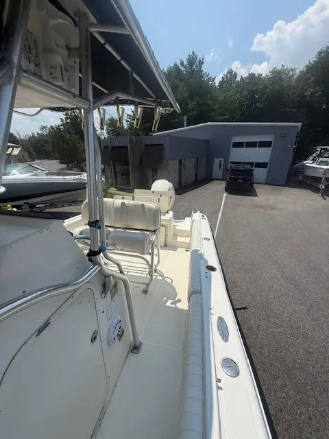 Slide: The Image of 2003 Hydra-Sports Vector 2400 CC boat docked near a modern building. - 9