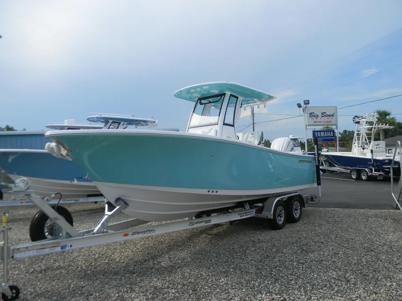 The Image of 2026 Sportsman Heritage 231 Center Console boat on trailer, displayed outdoors. - 1