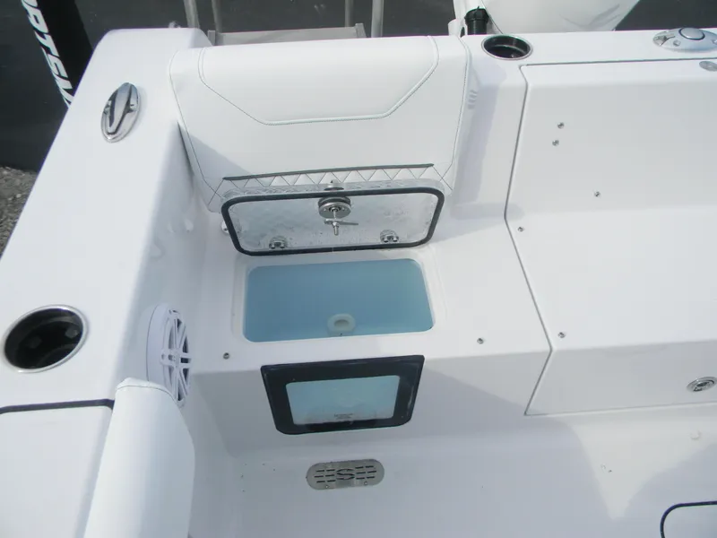 Slide: The Image of 2026 Sportsman Heritage 231 Center Console boat interior with storage and seating. - 13