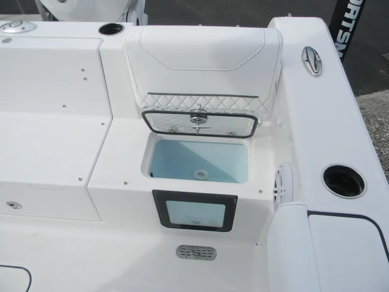 Slide: The Image of 2026 Sportsman Heritage 231 Center Console boat interior with storage compartment and seating. - 14