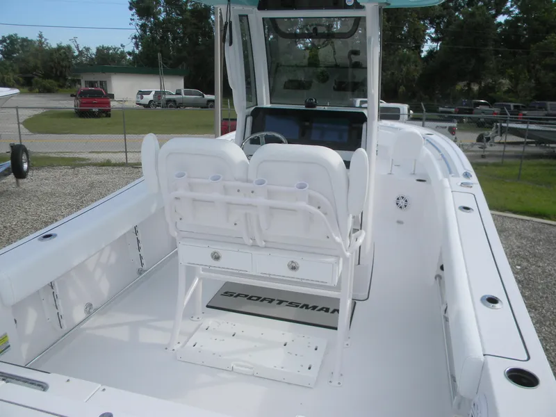 Slide: The Image of 2026 Sportsman Heritage 231 Center Console boat interior with seating and console view. - 3
