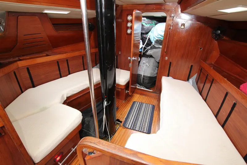 Slide: The Image of Interior of 1983 Baltic 38DP sailboat with wooden finish and cushioned seating. - 16