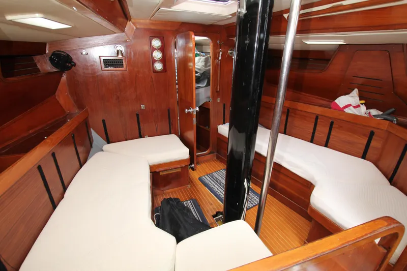 Slide: The Image of Interior of 1983 Baltic 38DP sailboat with wooden finish and cushioned seating. - 17