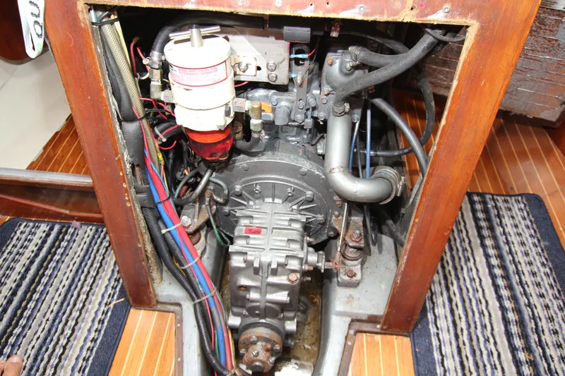 Slide: The Image of Engine compartment of a 1983 Baltic 38DP sailboat, showing detailed mechanical components. - 26