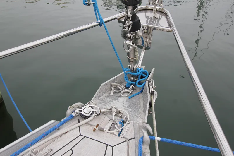 Slide: The Image of Bow of 1983 Baltic 38DP sailboat with ropes and fittings on calm water. - 3