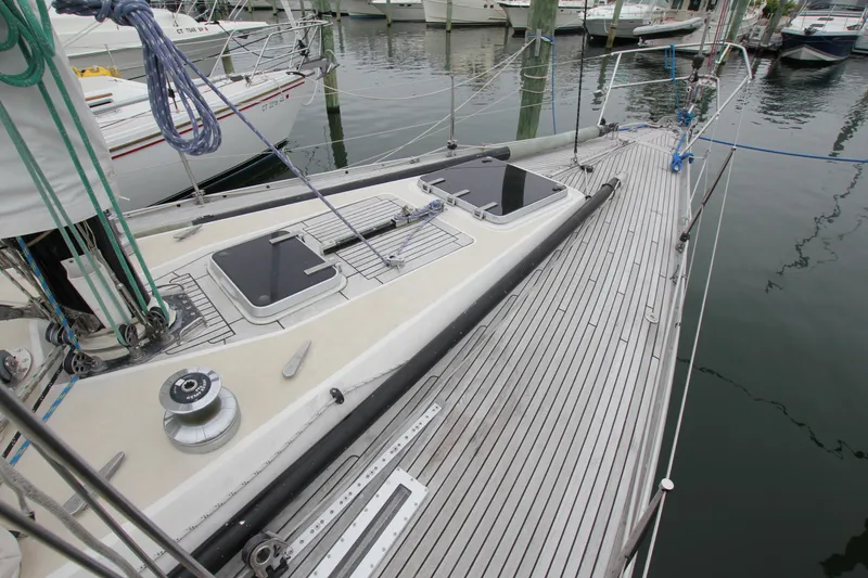 Slide: The Image of 1983 Baltic 38DP sailboat deck with winch and hatch, docked in marina. - 6