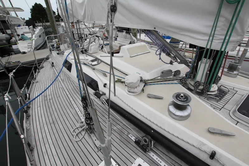 Slide: The Image of 1983 Baltic 38DP sailboat deck with rigging and winches at a marina. - 7