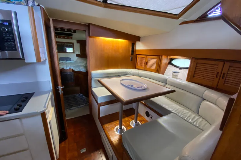 Slide: The Image of Interior of a 1990 Californian 52 yacht with cozy seating and dining area. - 71