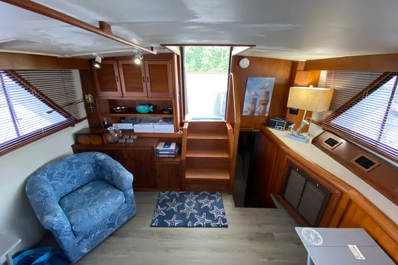 Slide: The Image of Cozy interior of a 1990 Californian 52 yacht with wooden furnishings and nautical decor. - 60