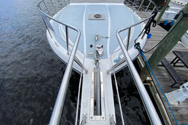 Slide: The Image of Bow view of a 1990 Californian 52 yacht docked at a marina. - 16