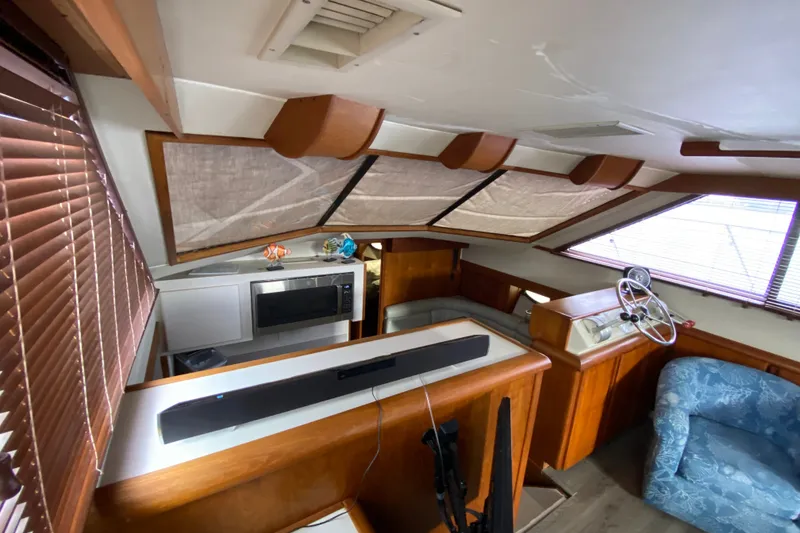 Slide: The Image of Interior of a 1990 Californian 52 yacht with wood accents and helm station. - 65