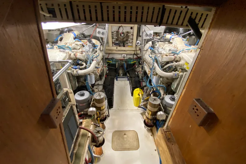 Slide: The Image of Engine room of a 1990 Californian 52 yacht, showcasing dual engines and mechanical components. - 45