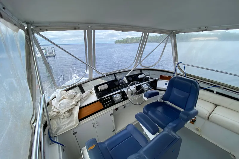 Slide: The Image of Interior view of 1990 Californian 52 yacht cockpit with blue seats and navigation equipment. - 27