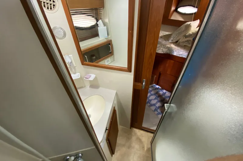 Slide: The Image of Compact bathroom in a 1990 Californian 52 yacht, featuring a shower and vanity. - 79
