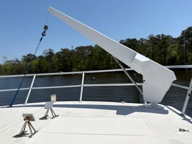 Slide: The Image of Bow of 1990 Carver Californian 52 yacht with anchor crane, river view. - 4