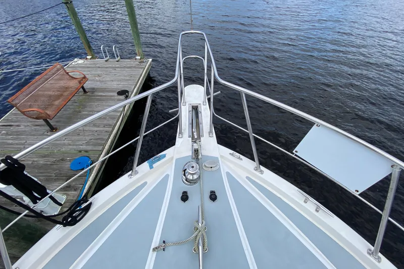 Slide: The Image of Bow of 1990 Californian 52 yacht docked at a wooden pier. - 15