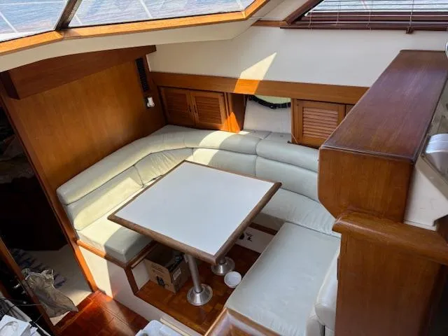 Slide: The Image of 1990 Carver Californian 52 yacht interior with white leather seating and wooden accents. - 5