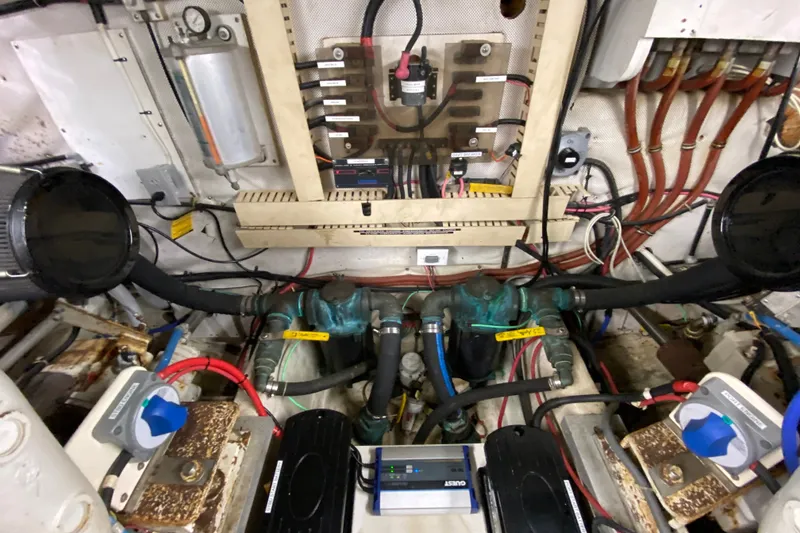Slide: The Image of Engine room of a 1990 Californian 52 yacht with complex wiring and plumbing. - 39