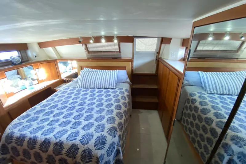 Slide: The Image of Cozy bedroom in 1990 Californian 52 yacht with nautical decor and mirrored closet. - 58
