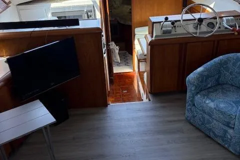 Slide: The Image of Interior of a 1990 Carver Californian 52 yacht with helm, seating, and TV. - 6