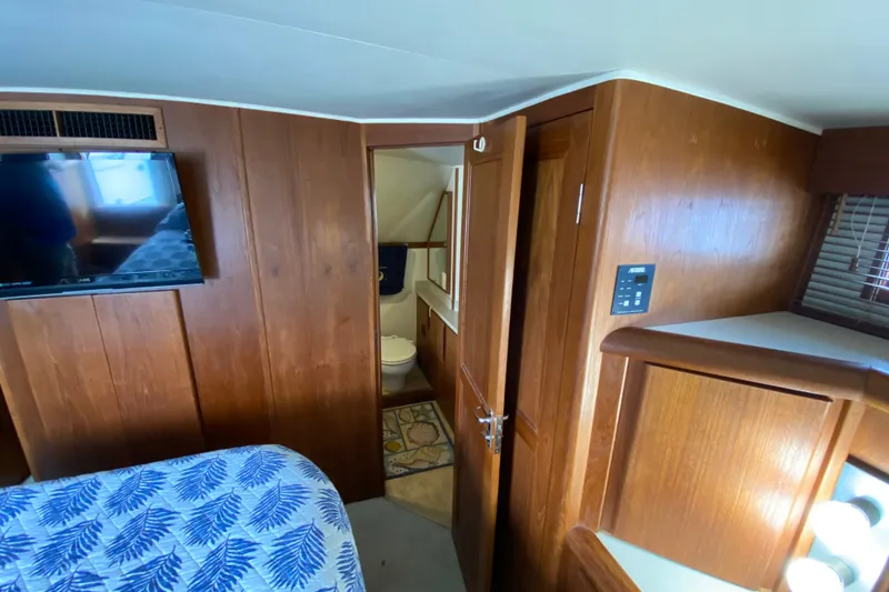 Slide: The Image of Interior of 1990 Californian 52 yacht with wood paneling and modern amenities. - 52