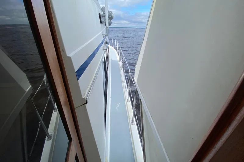 Slide: The Image of Side view of a 1990 Californian 52 yacht on open water under a cloudy sky. - 25