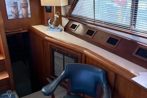 Slide: The Image of Interior of 1990 Carver Californian 52 yacht with wooden decor and nautical accents. - 7