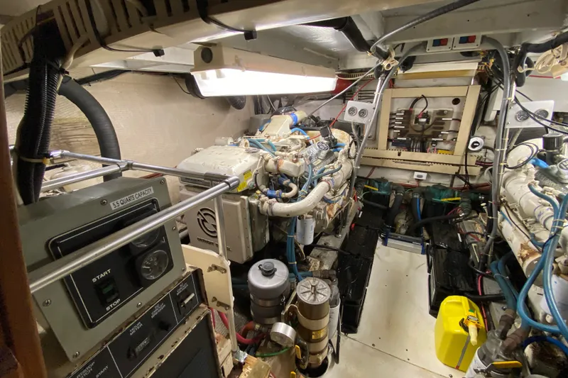 Slide: The Image of Engine room of a 1990 Californian 52 yacht, featuring dual engines and control panels. - 37