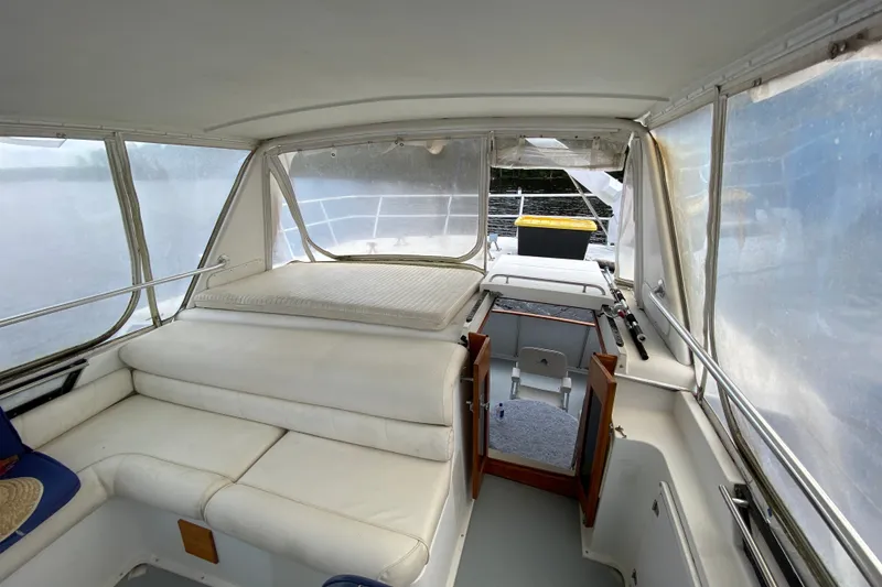 Slide: The Image of Interior view of a 1990 Californian 52 yacht with white seating and open cabin door. - 21