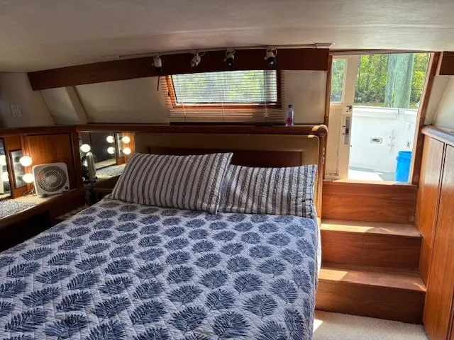 Slide: The Image of Bedroom interior of 1990 Carver Californian 52 yacht with cozy bed and natural light. - 8