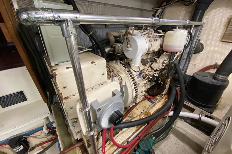 Slide: The Image of Engine room of a 1990 Californian 52 yacht, showcasing mechanical components and wiring. - 33