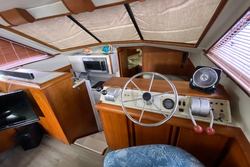 Slide: The Image of Interior of a 1990 Californian 52 yacht with helm, kitchen, and seating area. - 64