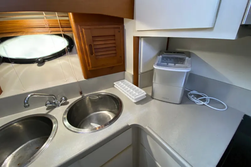 Slide: The Image of Kitchen area of a 1990 Californian 52 yacht with sink and ice maker. - 70