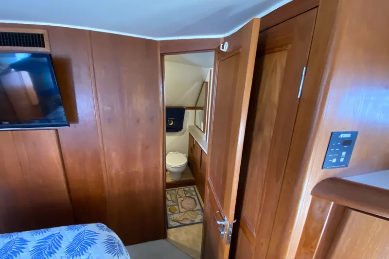 Slide: The Image of Interior of 1990 Californian 52 yacht with wooden paneling and bathroom view. - 55
