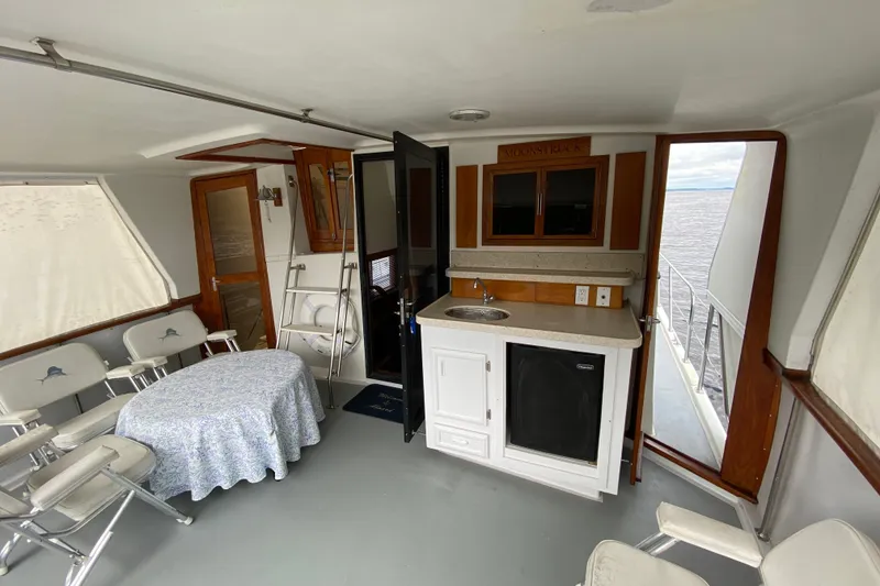 Slide: The Image of Interior of 1990 Californian 52 yacht with kitchenette and seating area. - 29