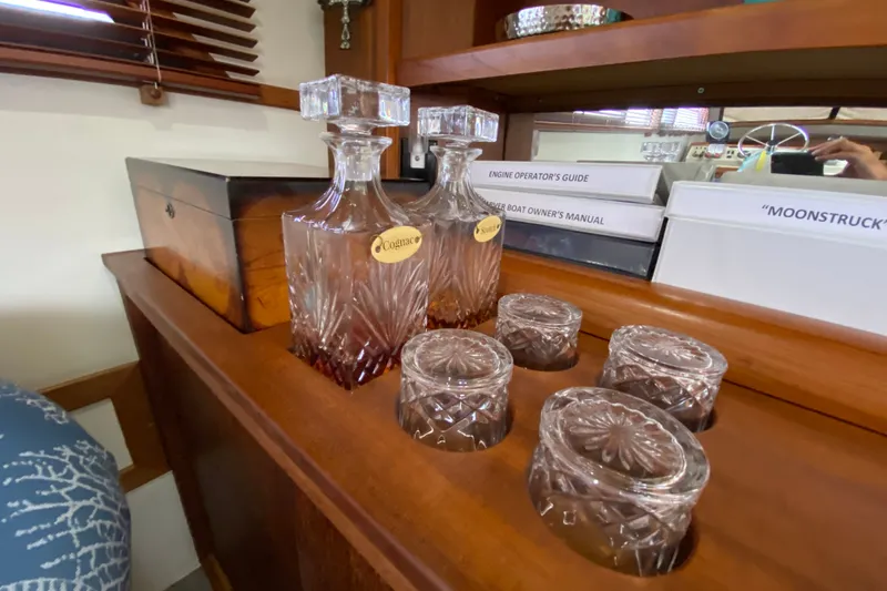 Slide: The Image of Crystal decanters and glasses on wooden shelf in 1990 Californian 52 yacht interior. - 63