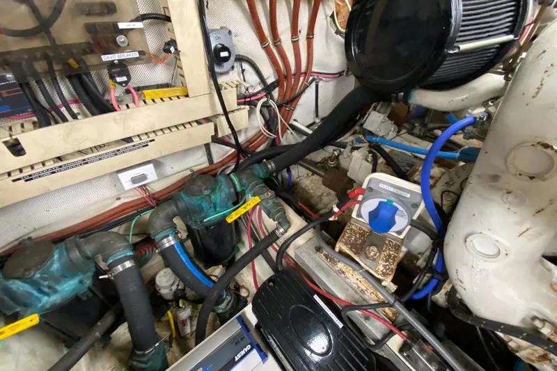 Slide: The Image of Engine room of a 1990 Californian 52 yacht with wiring and mechanical components. - 40