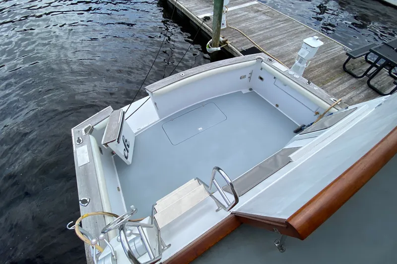 Slide: The Image of 1990 Californian 52 boat docked, featuring spacious deck and wooden railings. - 14