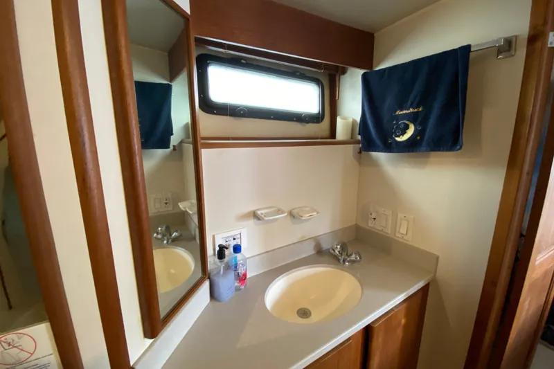 Slide: The Image of Bathroom interior of a 1990 Californian 52 yacht with sink and mirror. - 50