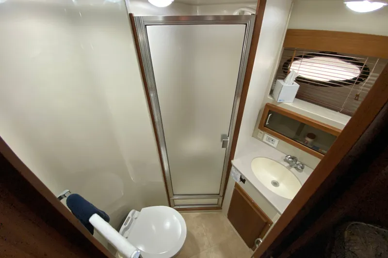 Slide: The Image of Bathroom interior of 1990 Californian 52 yacht with shower, sink, and porthole window. - 74