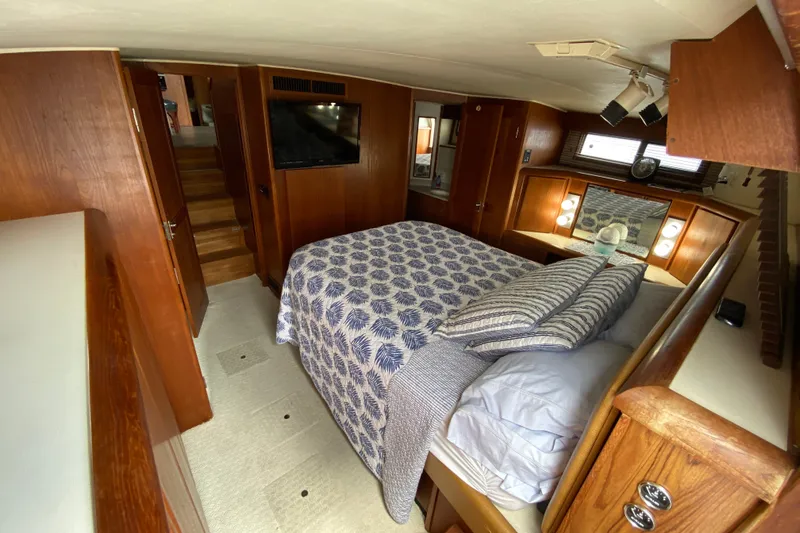 Slide: The Image of Cozy bedroom in 1990 Californian 52 yacht with wood accents and patterned bedding. - 47