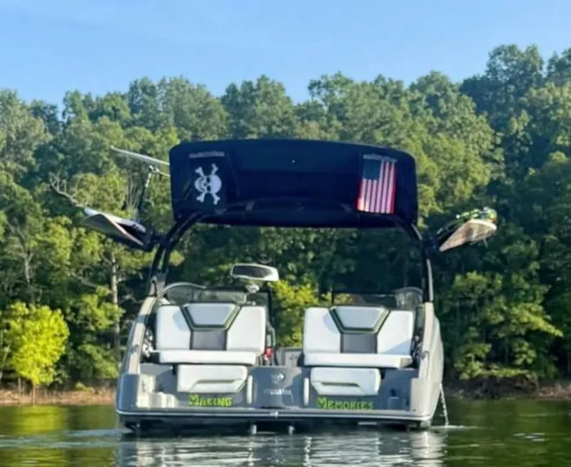 Slide: The Image of 2021 Yamaha Boats 255XD in a garage, sleek black design with modern features. - 2