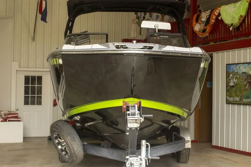 Slide: The Image of 2021 Yamaha Boats 255XD rear view with bright blue underwater lights. - 27