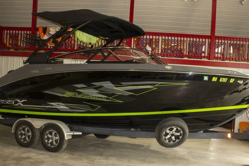 Slide: The Image of Battery compartment of 2021 Yamaha Boats 255XD with wiring and NOCO Genius charger. - 29