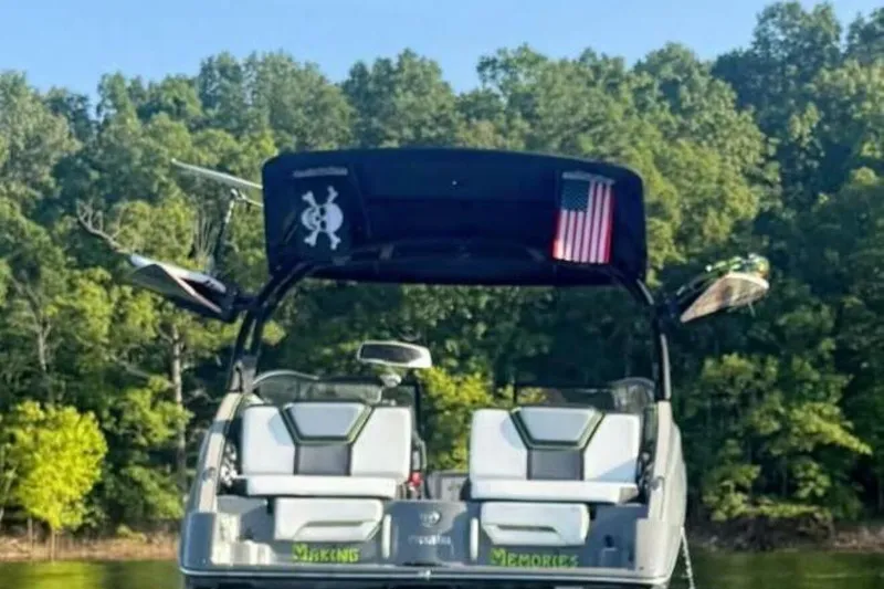 Slide: The Image of 2021 Yamaha Boats 255XD interior with speakers and canopy, inside a garage. - 41