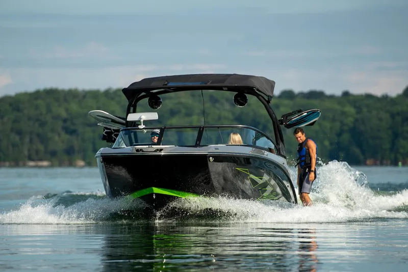 Slide: The Image of 2021 Yamaha Boats 255XD in a garage, sleek design with black and green accents. - 6